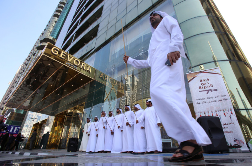 Emirati men perform outside the Gevora Hotel, the world’s tallest hotel, in Dubai