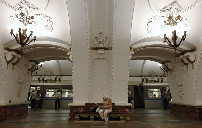 A woman sits on a bench at Prospekt Mira metro station in Moscow
