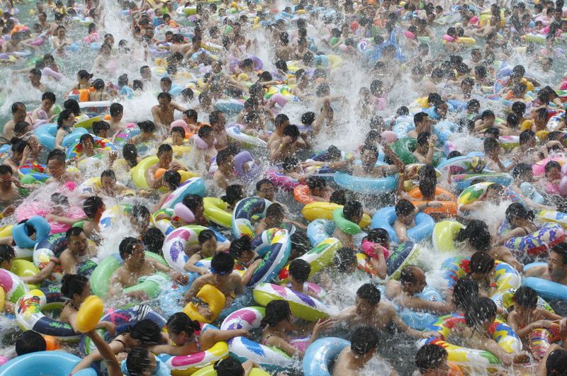 Residents crowd in a swimming pool to escape the summer heat during a hot weather spell in Daying county of Suining