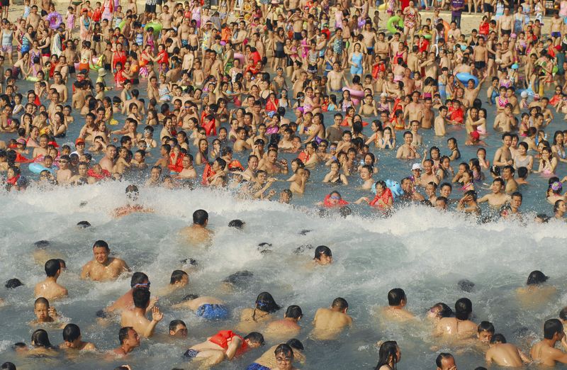 Visitors crowd in an artificial wave pool at a water park in Nanning