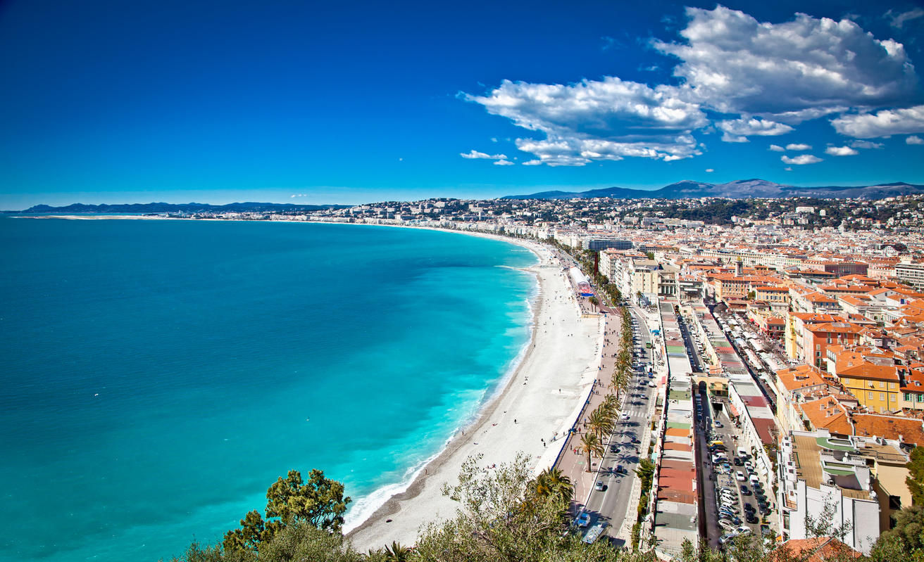 Panoramic view of Nice coastline and beach with blue sky.