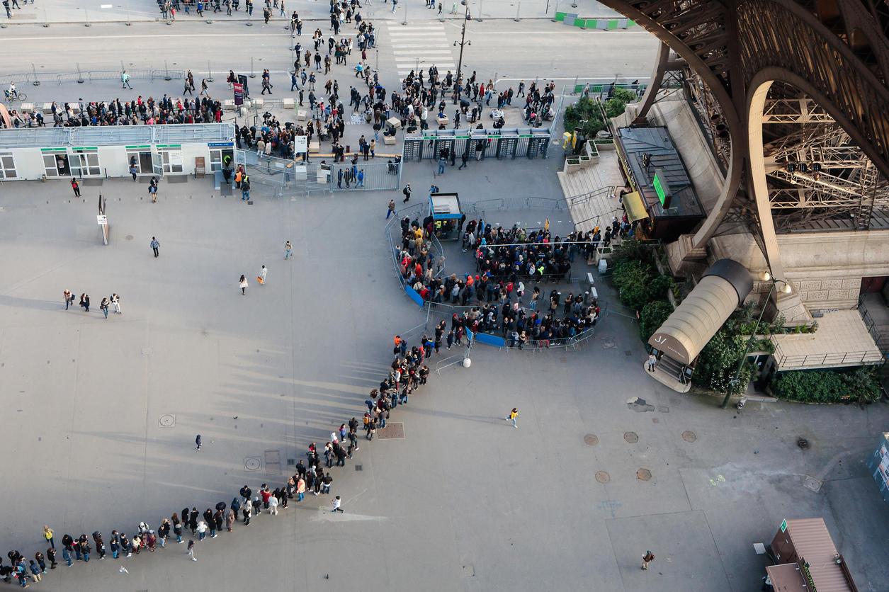Tourist queue under the Eiffel Tower