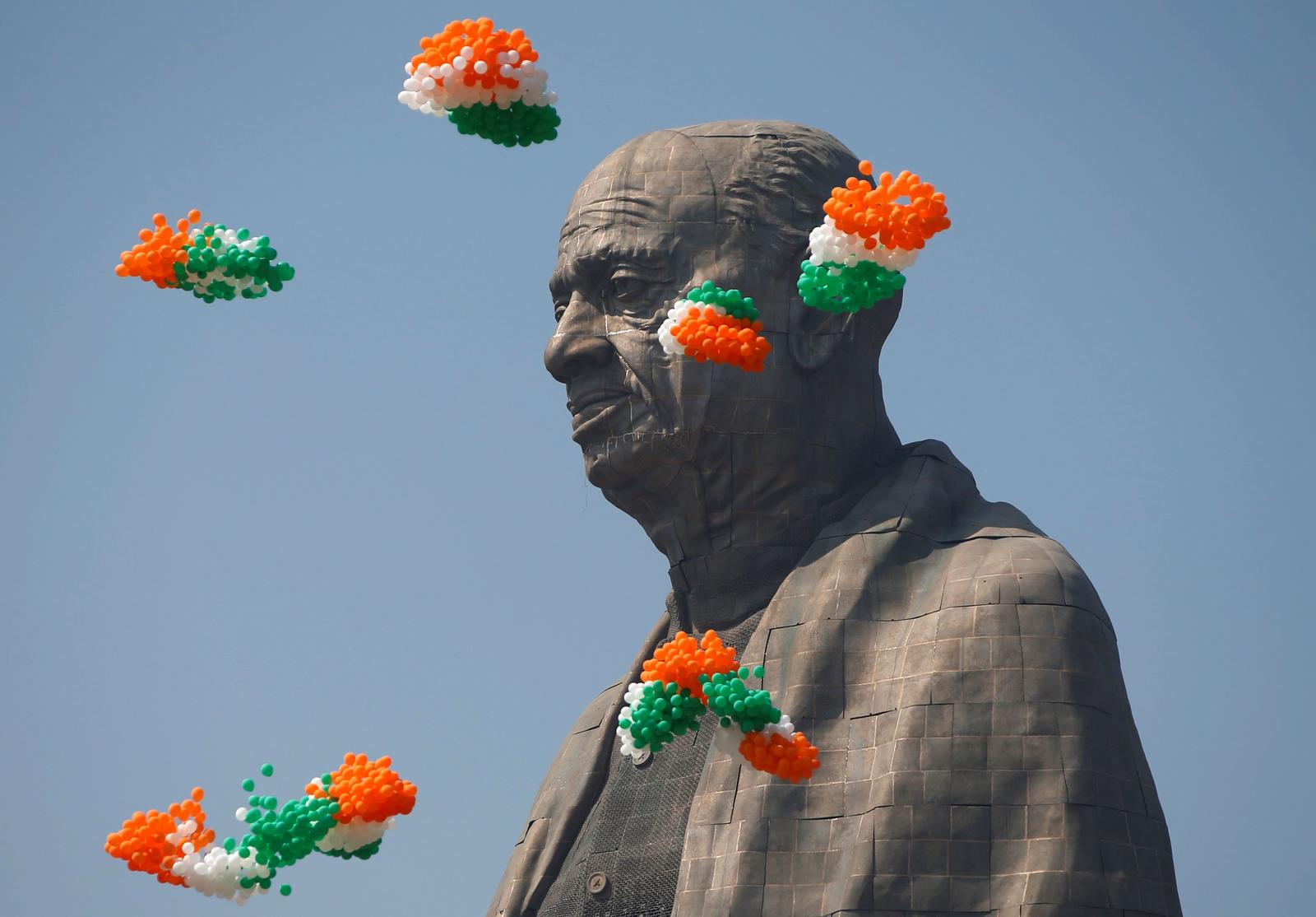 Indian tri-coloured balloons fly around the “Statue of Unity” portraying Sardar Vallabhbhai Patel, one of the founding fathers of India, during its inauguration in Kevadia