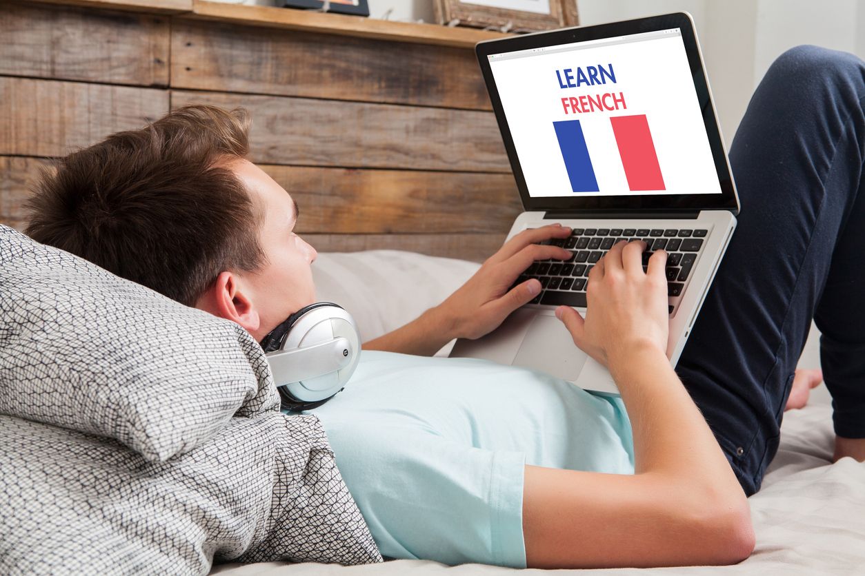 Man learning french at home.