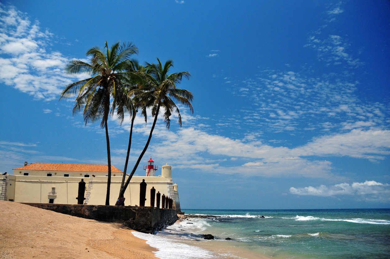 tropical beach, coconut trees and colonial fort